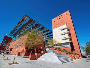 Low angle view of buildings against clear blue sky