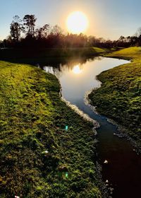 Scenic view of lake against sky during sunset