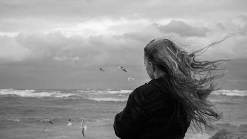 Teenage girl looking at sea