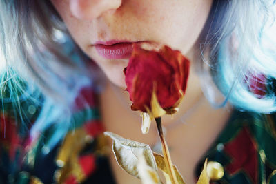 Close-up of woman with red flower