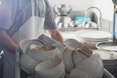 Midsection of man preparing food in kitchen