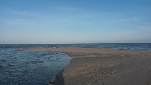 Scenic view of sea against blue sky