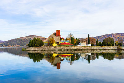 Reflection of building in lake against sky