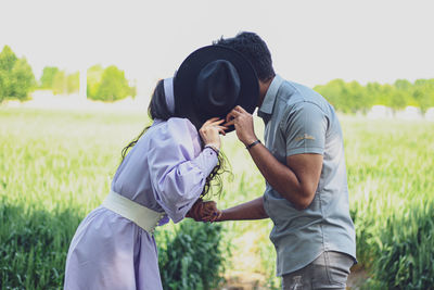 Rear view of man and woman standing on land