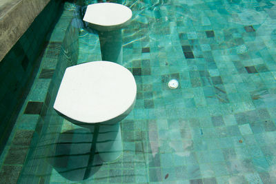 High angle view of illuminated lamps hanging on swimming pool