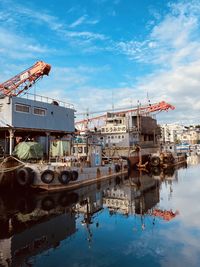 Ship moored in water against sky