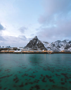 Scenic view of lake and snowcapped mountains against sky