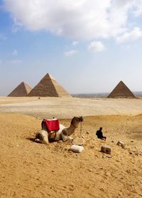 Pyramids against cloudy sky