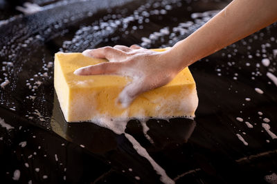 Women cleaning car wash with sponge yellow and foam stronger women cleaning car her concept person