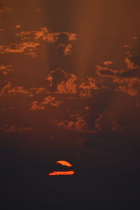 Scenic view of silhouette moon against sky at sunset