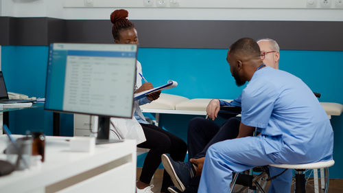 Rear view of man working in office