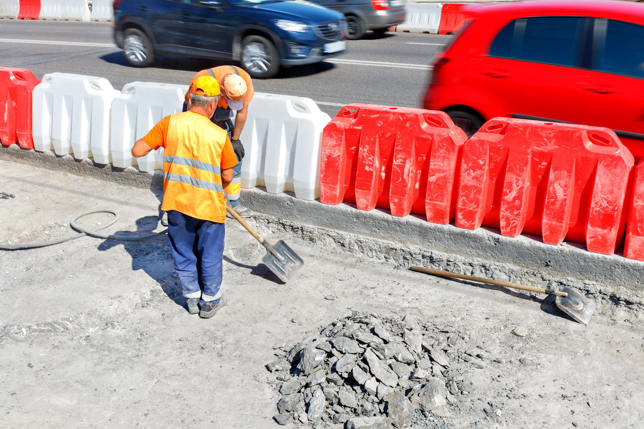 FULL LENGTH OF MAN WORKING ON BUS