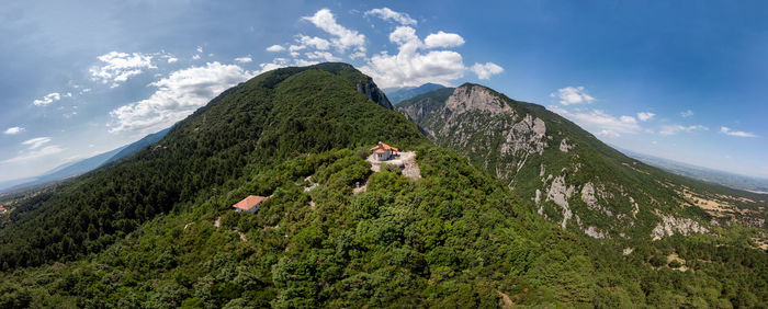 Scenic view of green mountains against sky