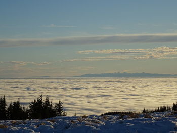 Scenic view of snow covered land against sky