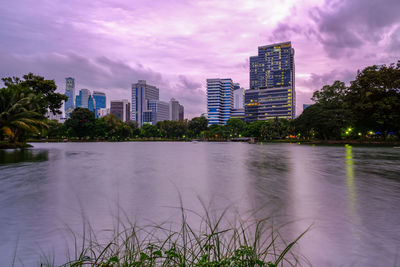 Scenic view of river and buildings against sky