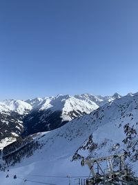 Scenic view of snowcapped mountains against clear blue sky