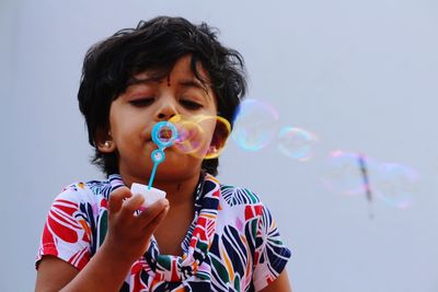 Portrait of boy holding bubbles