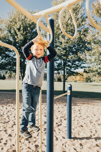 Boy playing on slide at playground