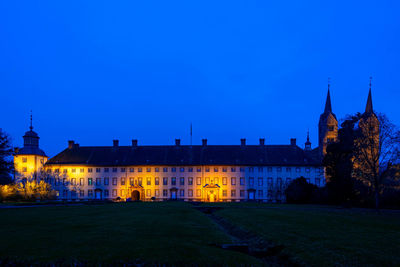 Buildings against blue sky at night