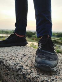 Low section of man standing on ground