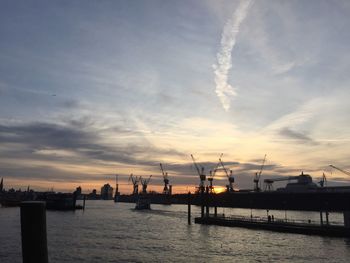 Boats in sea at sunset