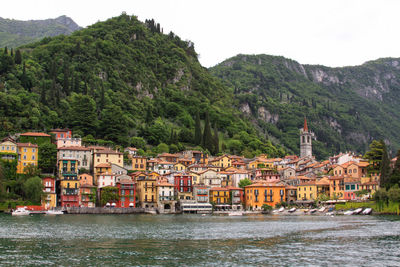 River by townscape against mountain