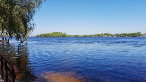 Scenic view of lake against clear blue sky