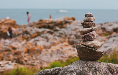 Close-up of rocks on beach against sky