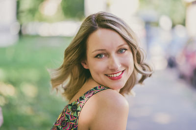 Close-up portrait of smiling young woman