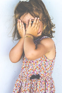 Close-up of girl covering face