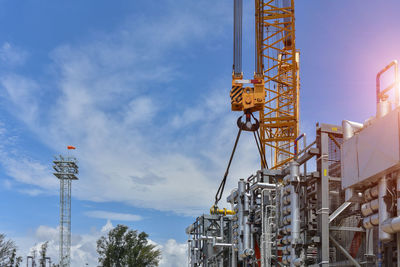 Low angle view of crane against sky