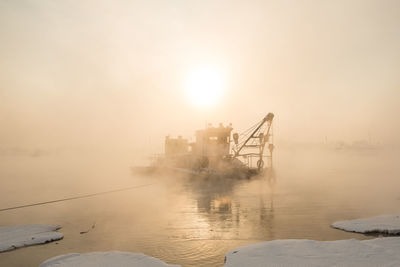 Scenic view of frozen lake against sky during sunset