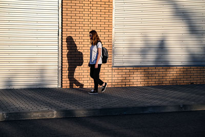 Side view of woman walking on street