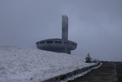 View of snow covered tower against sky