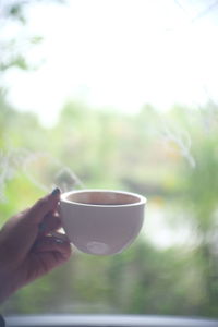 Hand holding coffee cup