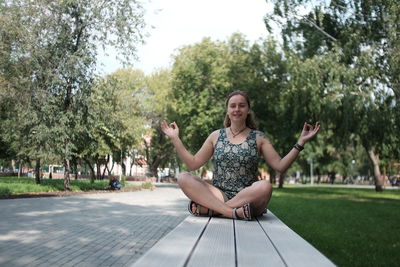 Full length of woman sitting in park