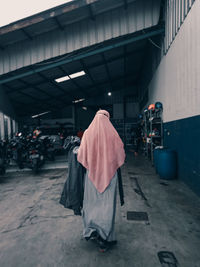 A woman is walking in the industrial area