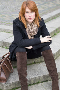 Portrait of young woman sitting outdoors