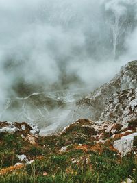 Scenic view of mountains against cloudy sky