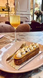 High angle view of decadent pastry and drink in plate on table