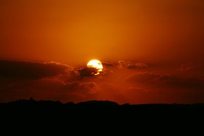 Silhouette landscape against sky at night