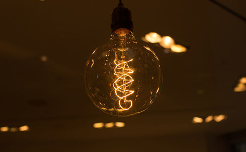 Low angle view of illuminated light bulb