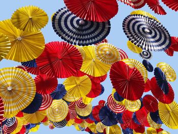 Low angle view of multi colored umbrellas hanging at market stall