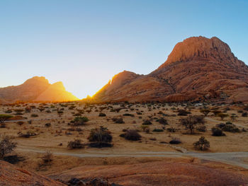 Scenic view of arid landscape against clear sky