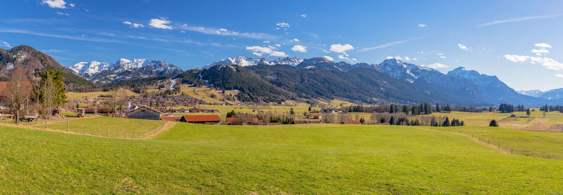 Scenic view of field and mountains against sky