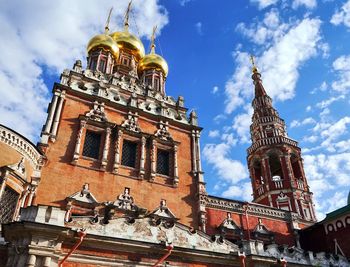 Low angle view of temple against cloudy sky