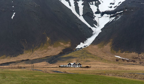 Scenic view of field and snowcapped mountains