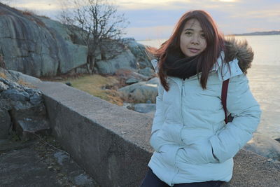 Portrait of young woman standing in snow