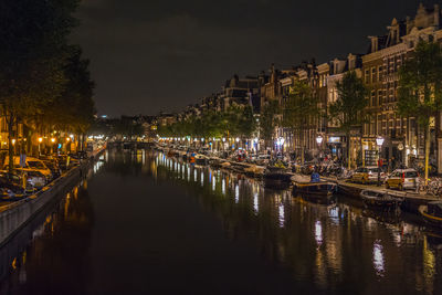 View of canal in city at night