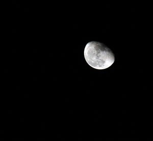 Low angle view of full moon against clear sky at night